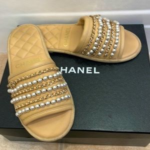 Gorgeous Chanel beige slides with pearl and gold accents.